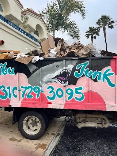 The malibu junk removal truck with a load of junk ready for removal